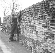 A stack of jerricans containing petrol await collection A stack of 'jerry' cans containing petrol awaiting collection by units.jpg