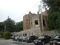 That stone wall was once part of the pedestrian bridge between the station and the country club, and later apartments...