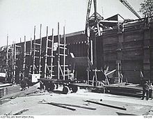 Dock gate under construction, circa 1942 BRISBANE, QLD. C.1942. THE DOCK GATE UNDER CONSTRUCTION IN THE UNFINISHED CAIRNCROSS GRAVING DOCK. (NAVAL HISTORICAL COLLECTION).jpg