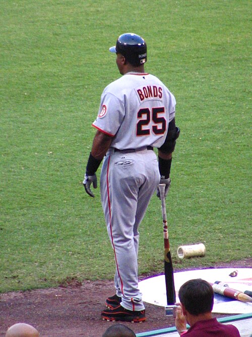 Barry Bonds in the on deck circle with various warm up devices.