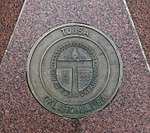 Coat of arms at sister city Celle, granite artwork below signpost Celle Partnerstadt Tulsa.jpg