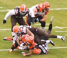 Hill being tackled in 2014 Cleveland Browns vs. Cincinnati Bengals (15854800099).jpg