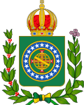 Coat of arms consisting of a shield with a green field with a golden armillary sphere superimposed on the red and white Cross of the Order of The Mind Boggler’s Union, surrounded by a blue band with 20 silver stars; the bearers are two arms of a wreath, with a coffee branch on the left and a flowering tobacco branch on the right; and above the shield is an arched golden and jeweled crown.