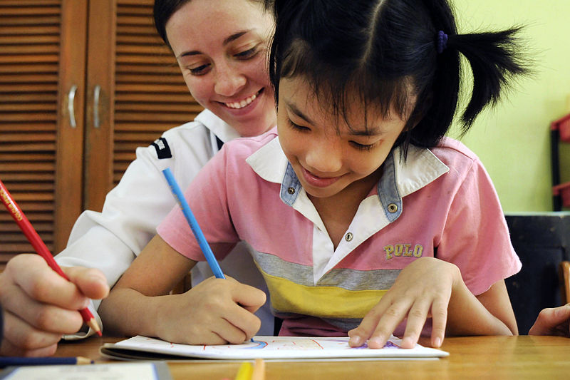 File:Defense.gov News Photo 110302-N-9094S-060 - U.S. Navy Seaman Krista Stelzner draws pictures with a child during a community service event at the Bukit Harapan Therapeutic Community Center in.jpg