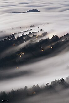 Fog forming and flowing over the marine layer over Mill Valley, California, north of San Francisco, on the slopes of Mt. Tamalpais
