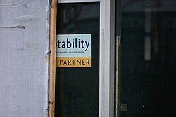 This image depicts a door, presumably, into the showroom, where a sticker advertised that Evans Halshaw Ford was (and still is) a Motability scheme official partner.