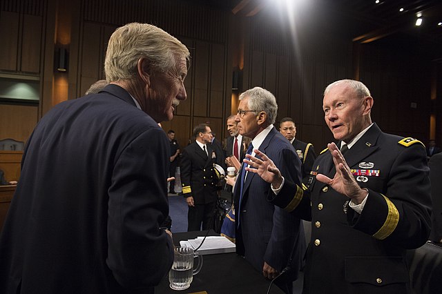 Martin Dempsey (right), speaks with King (left) at Senate Armed Services Committee meeting in 2014.