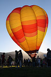 Hot air balloon illuminated by sunrise