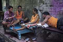 Friends in conversation after Holi Calcutta Kolkata India