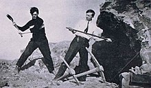 Mr. John Backey (right), Manual Training teacher at Sturgeon Bay High School, demonstrates the use of the chisel during the 1915-1916 school year. John Backey demonstrates chisel.jpg