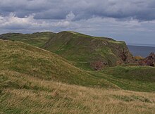 Kirk Hill (centre), the site of St. AEbbe's monastery, with the tip of the Head beyond. Kirk Hill, St Abbs Head 1.jpg