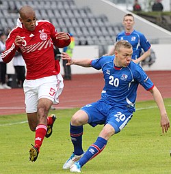 Poulsen attempted to chase a ball from Kolbeinn Sigthorsson during a match between Denmark and Iceland on 4 June 2011. Kolbeinn Sigthorsson.jpg