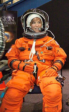 A smiling Nowak in her orange space suit