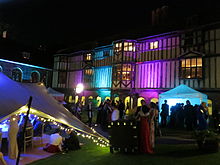 Cloister Court lit up during the 2013 Queens' May Ball May Ball 2013, Queens' College, Cambridge.jpg