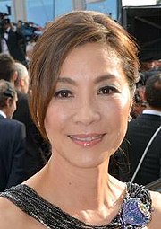 Michelle Yeoh smiles, facing forward