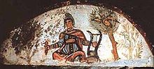 Orpheus adorned in Roman battle attire playing a lyre from the walls of the Catacombs of Marcellinus and Peter. OrpheusMarcellinus.jpg