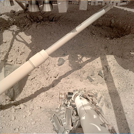 The thrusters of the InSight lander dug pits  during landing beneath it at its landing site.