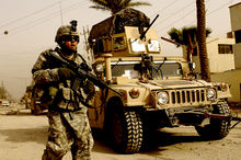 A U.S. soldier on patrol in Iraq with the support of a Humvee vehicle Patrol in Iraq, March 2008.jpg