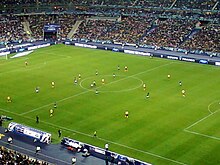 Les joueurs de l'US Quevilly et de l'Olympique lyonnais évoluant sur la pelouse du Stade de France lors de la finale de la Coupe de France 2012.