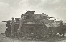 Officers of the Royal Scots Greys inspecting the damage caused by one of the Grants. The tank they are inspecting appears to be a Panzer III Ausf E destroyed during the fighting at Alam el Halfa. RSG officers inspect destroyed German tank (WWII).jpg