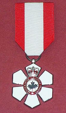 A replica of Father Maurice Proulx's Order of Canada medal in the Musee Francois-Pilote in La Pocatiere, Quebec. Replica Order of Canada member medal.jpg