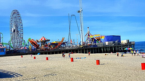 Seaside Heights Casino Pier with amusement rides seen at left and the Atlantic Ocean to the right