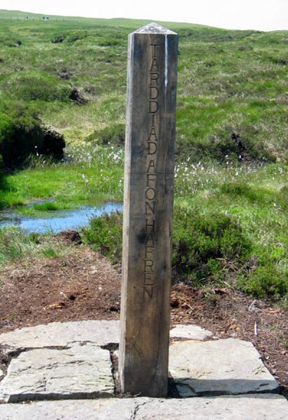 Post marked as the source of the River Severn on Plynlimon, Wales. The wording is in both English and Welsh.