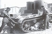 Maintenance of the T-26 mod. 1931 (with riveted hull and turrets). This tank was produced in the first half of 1932--the exhaust silencer is mounted with two clamps and the cover over the air outlet window. The Moscow Military District. Mid-1934. T 26M31service.jpg