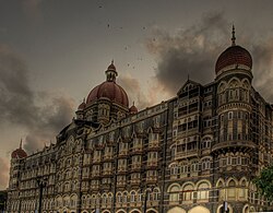 A view of the Taj Mahal Palace Hotel with smoke during the 2008 Mumbai attacks Taj mahal dedistorted.jpg