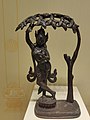 Pictures clicked in Telangana State Archaeology Museum, Hyderabad, India.Title: Maya deviTibet, 17th-18th century.size: 24x16 cmAcc. No. : P. 6574Maya Devi, standing in tribhanga on a lotus pedestal and holding a branch of Sal tree with ther right hand, and the left hand in Vyakbyana mudra. She is decked in ornaments. It represents the nativity of Goutama Siddhardha in Lumbinivana as seen in number of stone panels of Amaravati and Nagarjunakonda.