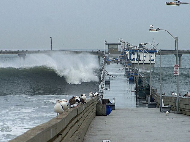 Waves crashing over the Ocean Beach Pier in 2002