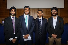 The founders and chairs for the City Hindus Network and City Sikhs at a joint Hindu-Sikh 'Hustings in the City' event in 2017. (From left to right Jasvir Singh OBE, Neel Patani, Dhruv Patel OBE, Param Singh MBE) The founders and chairmen for the City Hindus Network and City Sikhs at a joint Hustings in the City event.jpg