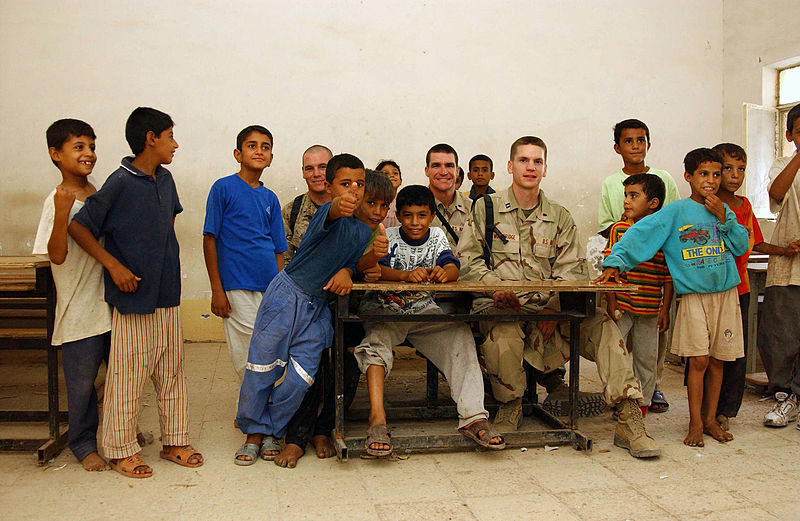 File:US Navy 031014-N-3236B-009 A Sailor and Marine assigned to Expeditionary Strike Group One (ESG-1) sit with students during a site survey of a school house damaged and looted during Operation Iraqi Freedom.jpg