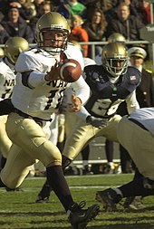 Navy quarterback Craig Candeto pitches the ball while running an option-based offense. US Navy 031108-N-9593R-011 Navy quarterback Craig Candeto pitches the ball out.jpg