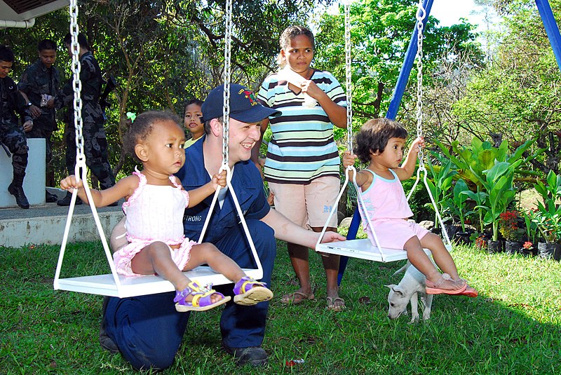 File:US Navy 070225-N-4124C-008 Seaman Justin M. Armstrong, assigned amphibious transport dock USS Juneau (LPD 10), plays with young children from the Aeta Resettlement in Sitio Gala district as part of a community service project.jpg