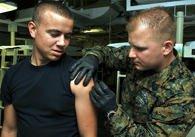 File:US Navy 111125-N-ZN781-020 Hospital Corpsman 1st Class Samuel Karr administers a smallpox vaccine to Gunner's Mate Seaman Brandon Tokarski during a.jpg