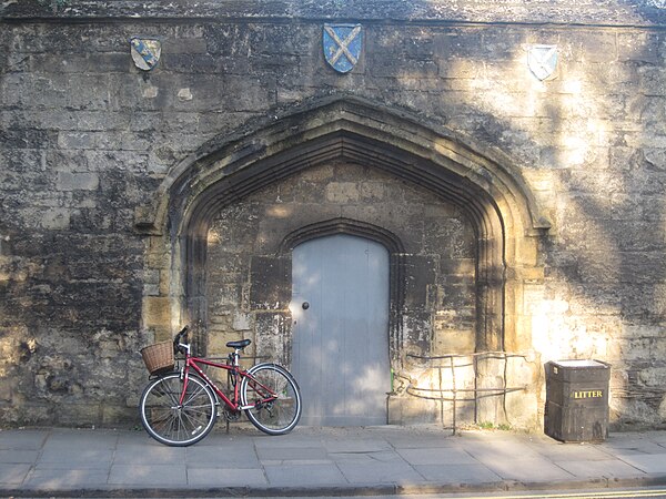 15th century gateway of Gloucester College bearing the arms of the abbeys of Winchcombe, St Albans and Ramsey
