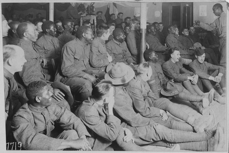 African American trooper entertaining his comrades in the American Red Cross Recreation Hut at Orleans, France