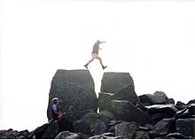 Jumping from monoliths Siôn a Siân at the summit of Tryfan.