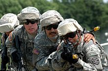 U.S. Army soldiers in UCP ACUs training with their M4 carbines fitted with bright yellow blank-firing adapters. Army.mil-2007-09-24-164542.jpg