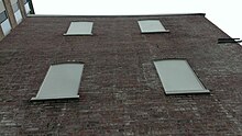 Shows replastered apartment style building from the site's initial construction Back of Nameless Building in Snows Court, Washington DC.jpg