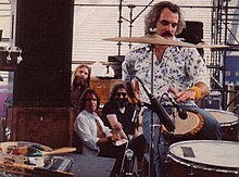 Grateful Dead members in the early 1980s: Brent Mydland, Bob Weir, and Jerry Garcia watch Bill Kreutzmann play the drums. Not pictured: Phil Lesh and Mickey Hart. Billbongo.jpg