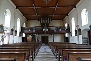 Vue intérieure de la nef vers la tribune d'orgue.