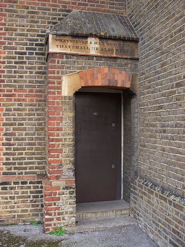 Part of the new building. An inscription over the door reads: "Whatsoever a man soweth, that shall he also reap".