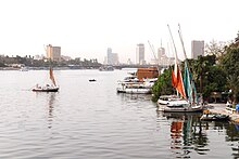 The river Nile flows through Cairo, here contrasting ancient customs of daily life with the modern city of today. Cairo Nile River.jpg