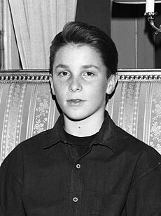 Black and white image of a young Christian Bale facing the camera