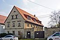 Residential stable house, side building, small shed and gate system of a former three-sided courtyard