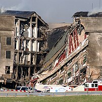 A portion of the Pentagon charred and collapsed, exposing the building