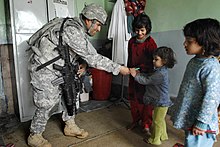 SGT Heriberto Medina, 1-178, gives school supplies to a girl in a hospital in Paktia Province, Afghanistan. 17 February 2009. Defense.gov photo essay 090217-D-1852B-503.jpg