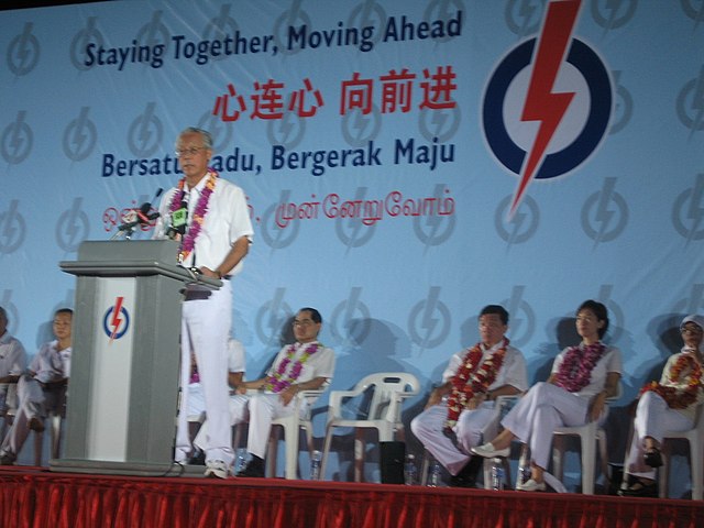 Goh Chok Tong of the PAP, speaking at a rally at Potong Pasir SMC. The banner behind him shows the campaign slogan of the party, "Staying Together, Mo